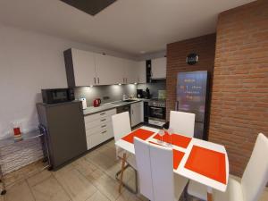 a kitchen with a table and chairs and a kitchen with a refrigerator at Appartment 129 in Tossens in Tossens