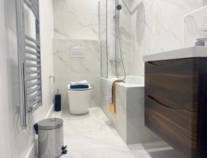 a bathroom with a shower and a toilet and a sink at Elevate at Fleet Heights Apartment Seven in Fleet