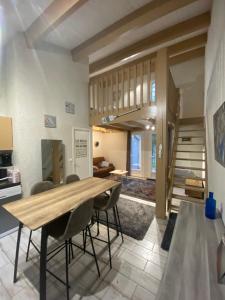 a dining room with a wooden table and chairs at Le Cocon Gite in Saint-Trojan-les-Bains