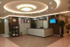 a lobby with a reception desk and a circular ceiling at Florida Inn Hotel in Najran