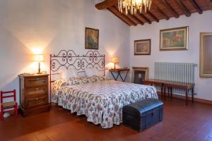 a bedroom with a bed and a dresser and a table at Ginestraio in Santalbino by VacaVilla in Sorrezzana +41 photos