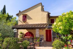 a house with red doors and a patio at Ginestraio in Santalbino by VacaVilla in Sorrezzana