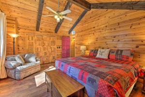 a bedroom with a bed and a couch in a cabin at Near Dining, Hiking and Golf Pinetop Log Cabin! in Indian Pine