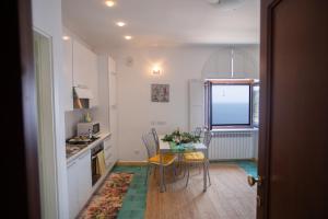 een kleine keuken met een tafel en stoelen in een kamer bij Casa Bianca: delightful apartment in Ravello in Ravello