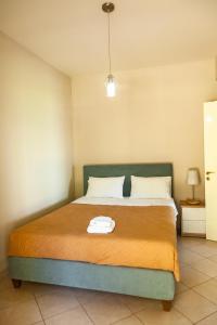 Postel nebo postele na pokoji v ubytování Brunello Seaside Apartments