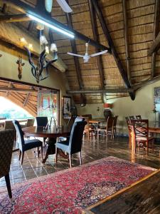 a dining room with a table and chairs and a ceiling at Ithaba Falls Guest Farm Farm L59, Buffelsvley, Burgersfort, 1150 in Boerboomskraal