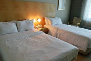 a hotel room with two beds and a telephone at Daegu Grand Hotel in Daegu