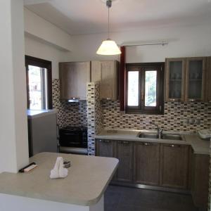 a kitchen with wooden cabinets and a white duck on a counter at Aurora in Platanias