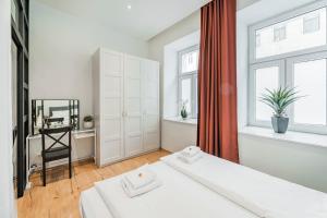 Łóżko lub łóżka w pokoju w obiekcie ZEUS Design Apartments Herz