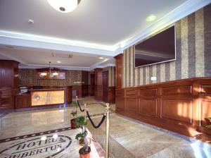 a hotel lobby with a television on the wall at ApartHotel Hubertus in Białystok