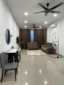 a living room with a couch and a ceiling fan at Harith sofea condo with pool in Kuala Terengganu