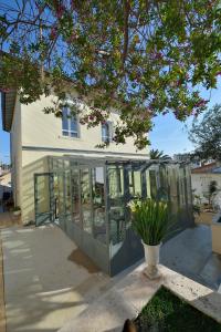 a house with glass doors and a patio at B&B Villa Du Roc Fleuri in Cannes