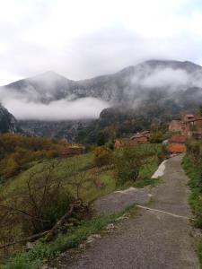 a view of a valley with clouds in the mountains at Apartamentos El Abertal in Navedo