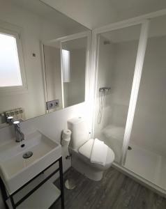 a bathroom with a toilet and a sink and a shower at PATOS BEACH HOUSE in Nigrán