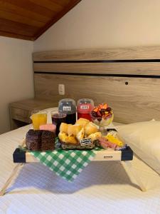 a tray of food on top of a bed at Pousada Schmitz in Canela +79 photos