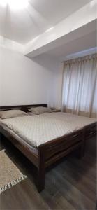 a bed sitting in a room with at Apartman ALTA in Vlasic