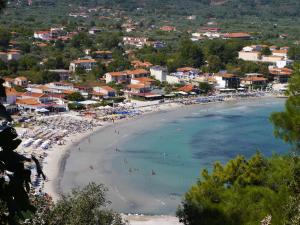 a view of a beach with people in the water at Blue Sea Beach Resort in Skala Potamias