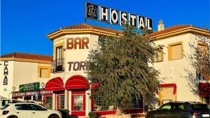 a hotel with a sign on the top of a building at Hostal Torresmancha in La Guardia