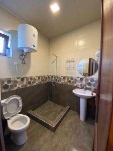 a bathroom with a toilet and a sink at Onestep in Kutaisi