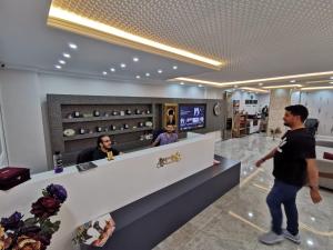 a man standing in front of a counter in a restaurant at Aysa Suite in Trabzon