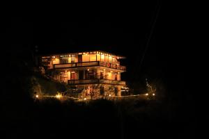 a large house at night with its lights at Odin Hostel Shoja in Shoja