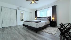 a bedroom with a bed and a large window at Double Suite Santa Monica - Free Parking in Santa Monica