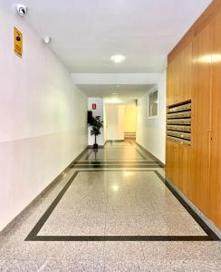 an empty hallway in a building with a plant at Pensión Peiró in Barcelona