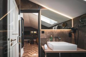 
a bathroom with a sink and a toilet at Villa Sonnenhof Boutique-Hotel in Bad Reichenhall
