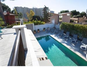 een zwembad met ligstoelen naast een gebouw bij Luna Bay Palma in Palma de Mallorca