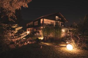 a large house at night with a lit up at Villa Sonnenhof Boutique-Hotel in Bad Reichenhall