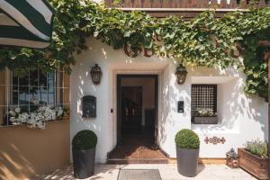 an entrance to a white house with ivy on the wall at Villa Sonnenhof Boutique-Hotel in Bad Reichenhall