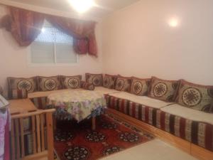 a living room with a couch and a table at Maison Jad in Ifrane