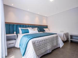 a bedroom with two beds with blue and white at Hotel Locanda Casa D'Oro in Gramado +54 photos