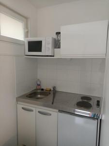 a small kitchen with a sink and a microwave at Studio Vacances in Saint Malo