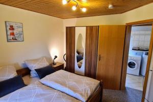 a bedroom with a bed and a washer and dryer at Ferienwohnung mit Pool in Nordleda