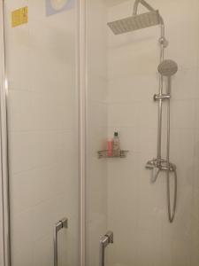 a shower stall with a glass door with a shower at Studio Vacances in Saint Malo