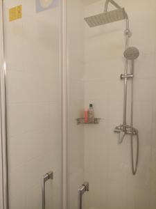 a shower stall with a glass door with a shower at Studio Vacances château Malo saint Malo in Saint Malo