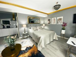 a bedroom with a bed and a table in it at Killeröd Boutique Apartments in Båstad