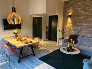 a living room with a table and a couch at Broncks Apartment 1 - Modern 2-Bedroom in the Heart of Tórshavn in Tórshavn