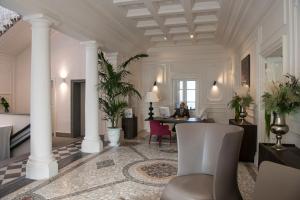 a lobby with a table and chairs and columns at Dimora Palanca Boutique & SPA in Florence