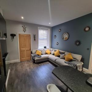 a living room with a couch and a table at Kelvin Suite in Jesmond