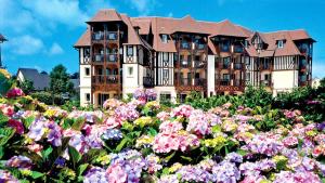 a large building with flowers in front of it at LE LOFT DU GOLF DE DEAUVILLE in Deauville