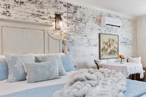 a bedroom with a bed with a blanket and pillows at The Old Liberty Schoolhouse in Azle