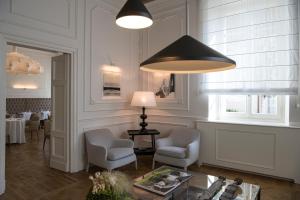 a living room with two chairs and a table and a lamp at Dimora Palanca Boutique & SPA in Florence +99 photos