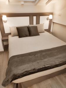 a bedroom with a large bed with pillows at Tuffonelblu in Ventimiglia