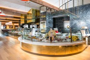 a display case in a restaurant with a lot of food at The Vanderpump Las Vegas Hotel & Casino - A Caesars Rewards Destination in Las Vegas