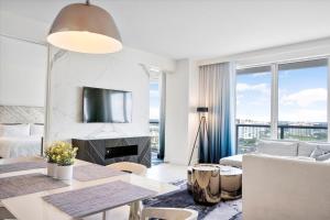 a white living room with a fireplace and a couch at W Residences 2 Bedroom Suite condo in Fort Lauderdale