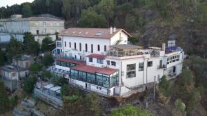 a large white house on top of a mountain at Luna Convento Copanello B&B in Stalettì