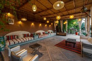 a living room with couches and tables and lights at Domaine Alma Marrakech in Marrakesh