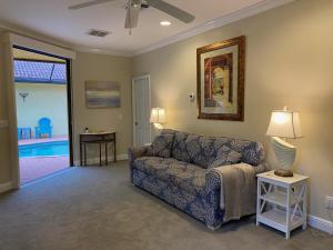 a living room with a couch and a table at Paradise Found - Private Oasis with Heated Pool on Marco Island in Marco Island